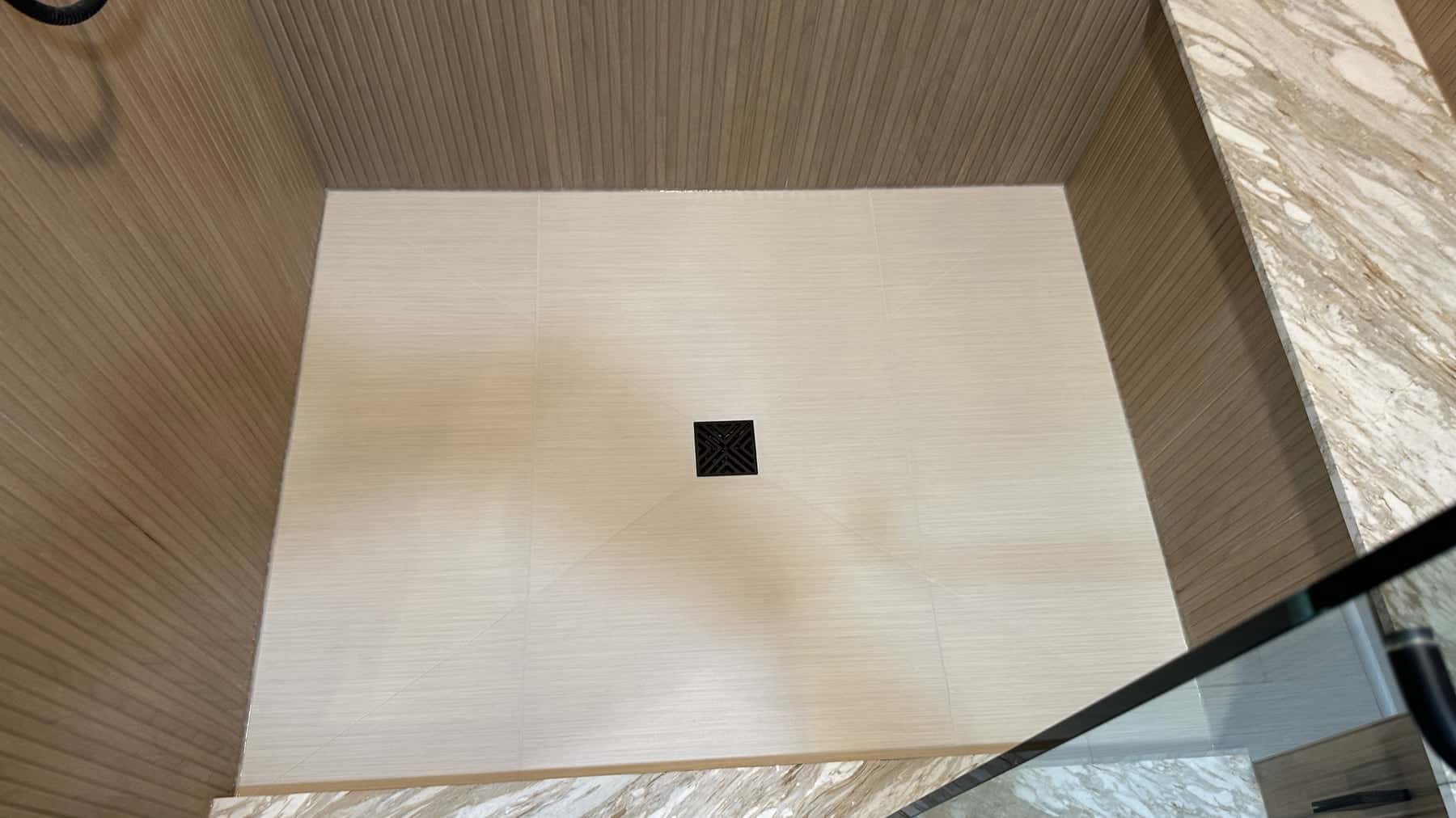 After repair: close view of the finished shower floor and square drain